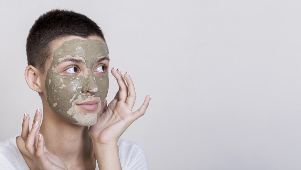 Young woman applying a gentle face mask for blackheads